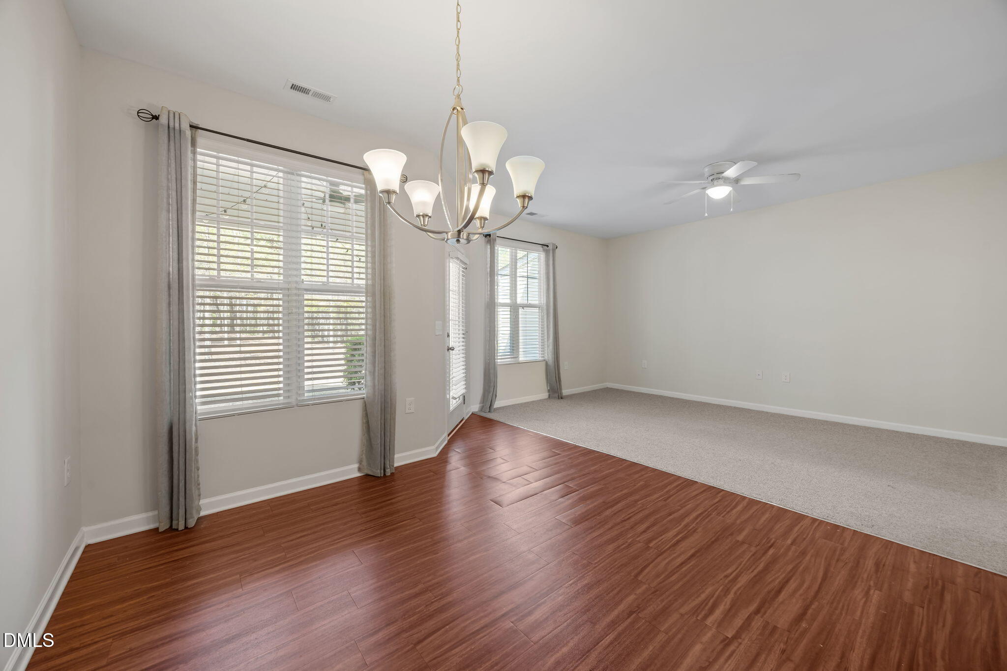 1005 Epiphany Road Morrisville, NC 27560 - Photo 8 of 23 a view of an empty room with wooden floor and a window