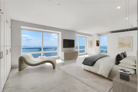 a bedroom with a bed and glass window