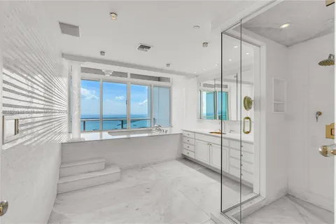 a large white kitchen with a large window