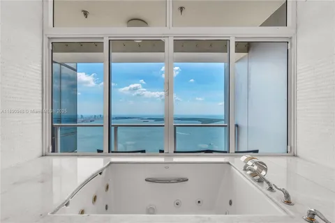 a bathroom with a bathtub and a window