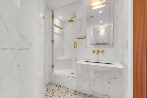 a bath room with a sink a toilet and shower