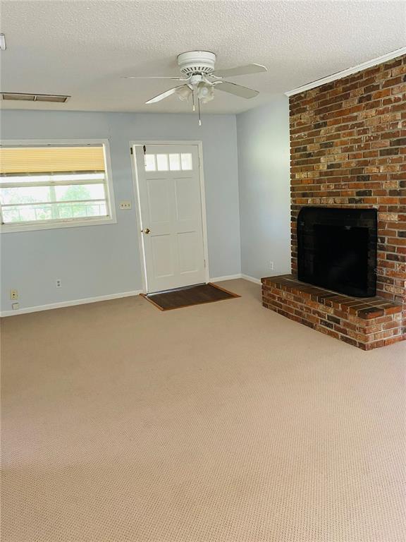 1334 Livingston Road Lutz, FL 33559 - Photo 5 of 7 a view of an empty room with a fireplace and a window