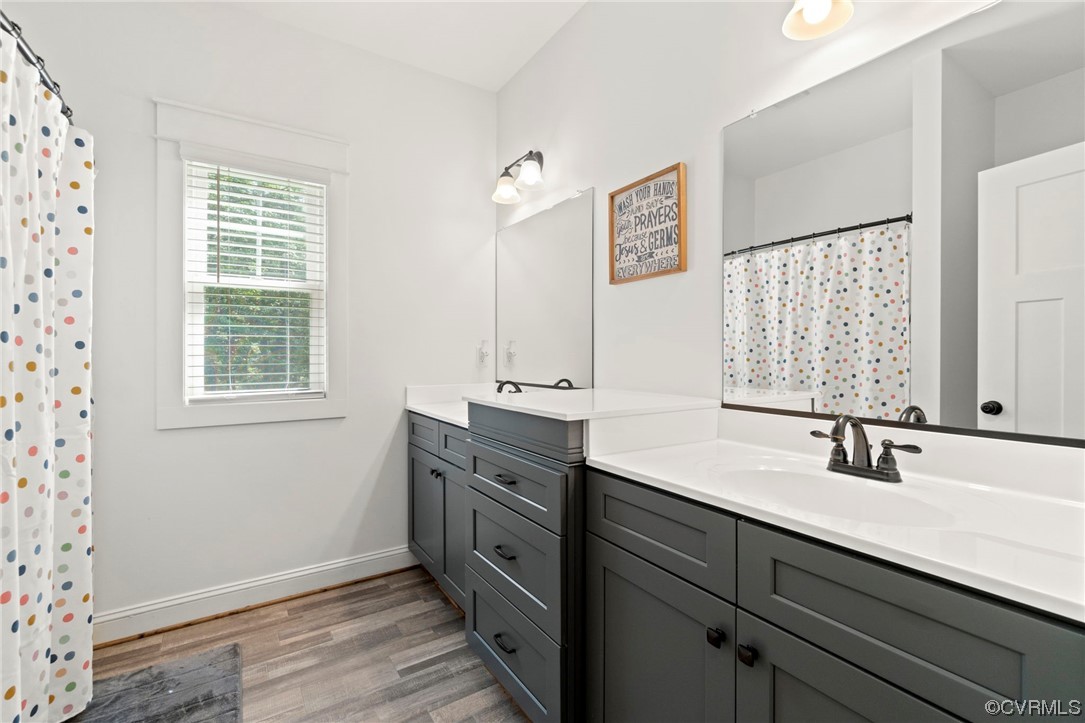 1110 Dorset Road Moseley, VA 23120 - Photo 28 of 32 a bathroom with a double vanity sink window and two mirror