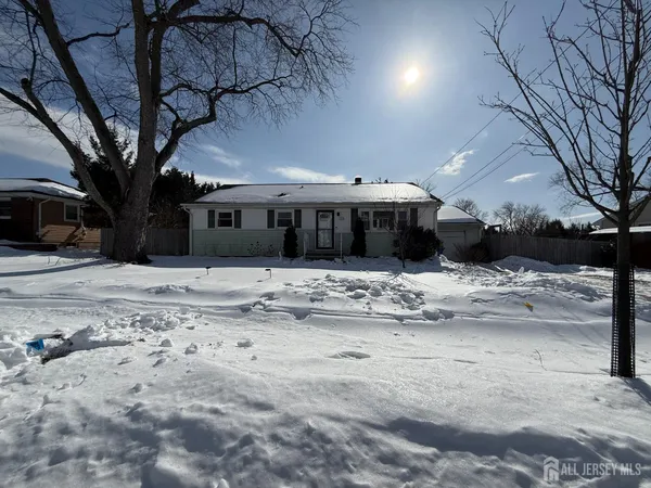 a view of a house with a snow in the yard