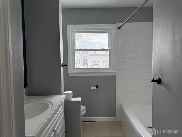 a bathroom with a bathtub and window