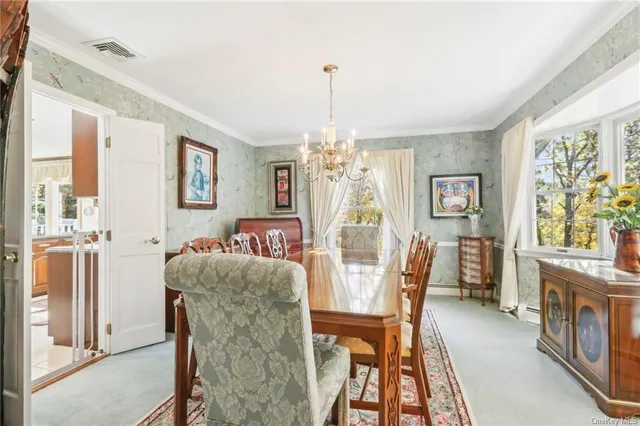 a dining room with furniture a chandelier and wooden floor