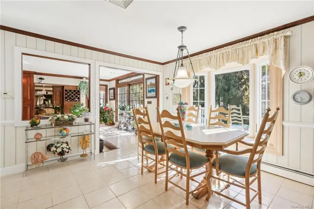 a view of a dining room with furniture wooden floor and a chandelier