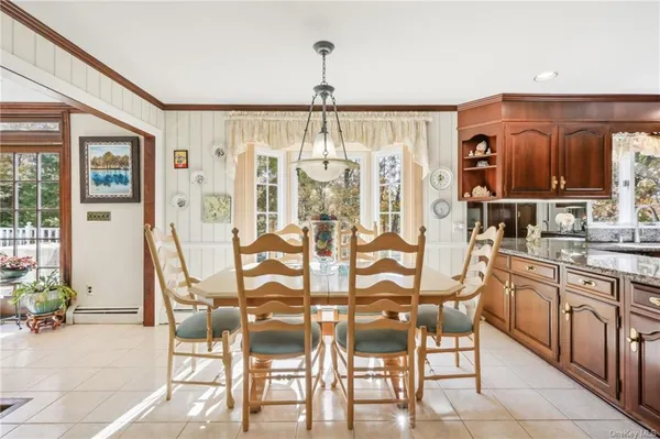 a view of a dining room with furniture and chandelier