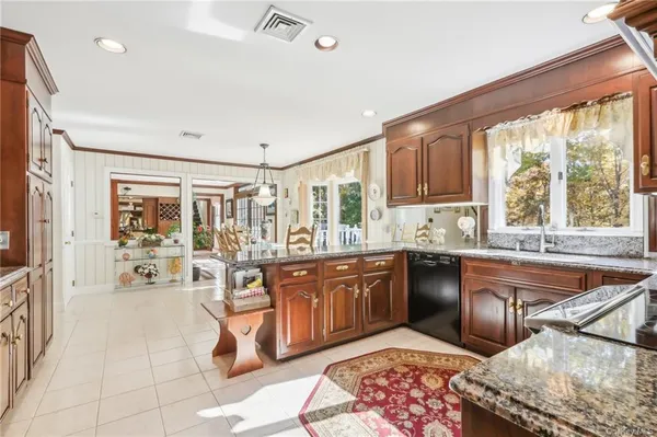 a large kitchen with kitchen island granite countertop a large window and counter space