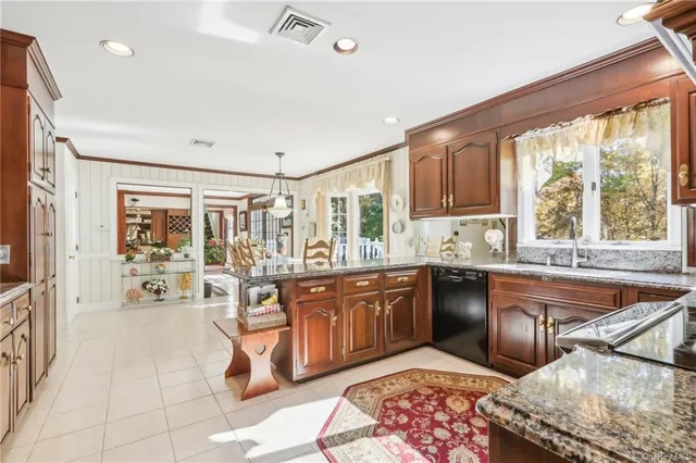 a large kitchen with kitchen island granite countertop a large window and counter space