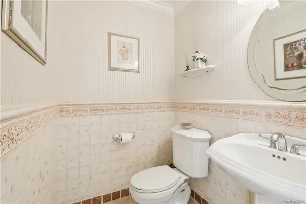 a bathroom with a sink mirror and toilet