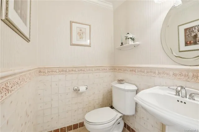 a bathroom with a sink mirror and toilet