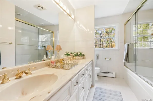 a spacious bathroom with a tub sink and mirror