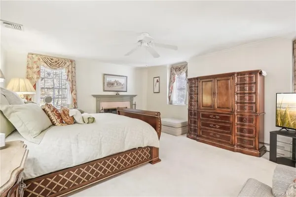 a bedroom with a bed and dresser with mirror