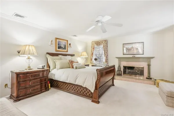 a spacious bedroom with a bed and a chandelier