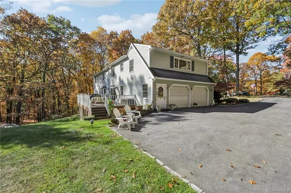 a view of a house with backyard and sitting area