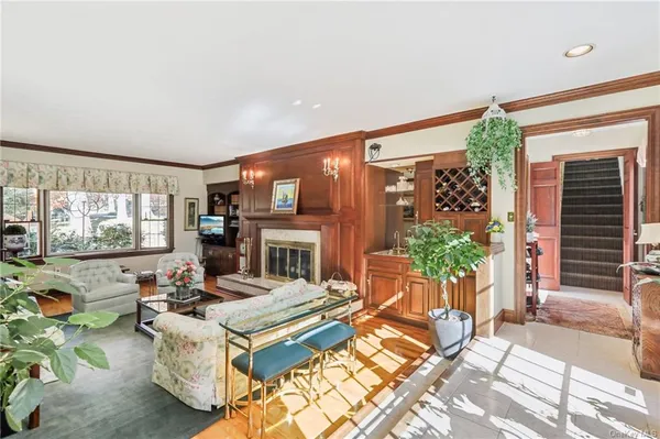 a living room with fireplace furniture and a large window