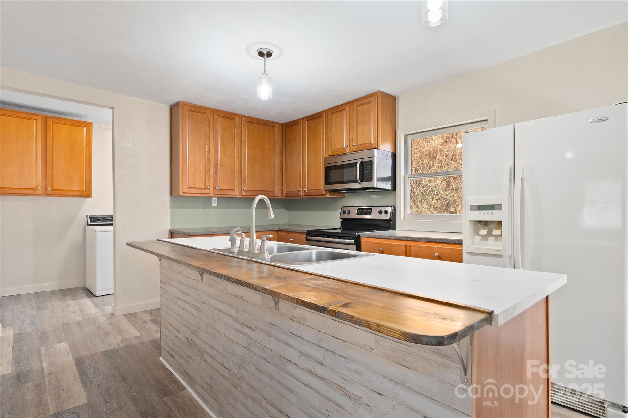 1901 Murray Road Canton, NC 28716 - Photo 11 of 21 a kitchen with stainless steel appliances granite countertop a sink a stove and a wooden floors