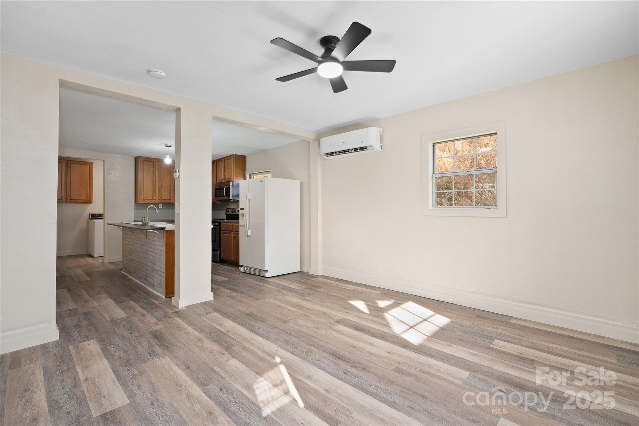 1901 Murray Road Canton, NC 28716 - Photo 5 of 21 a view of a livingroom with wooden floor and a ceiling fan