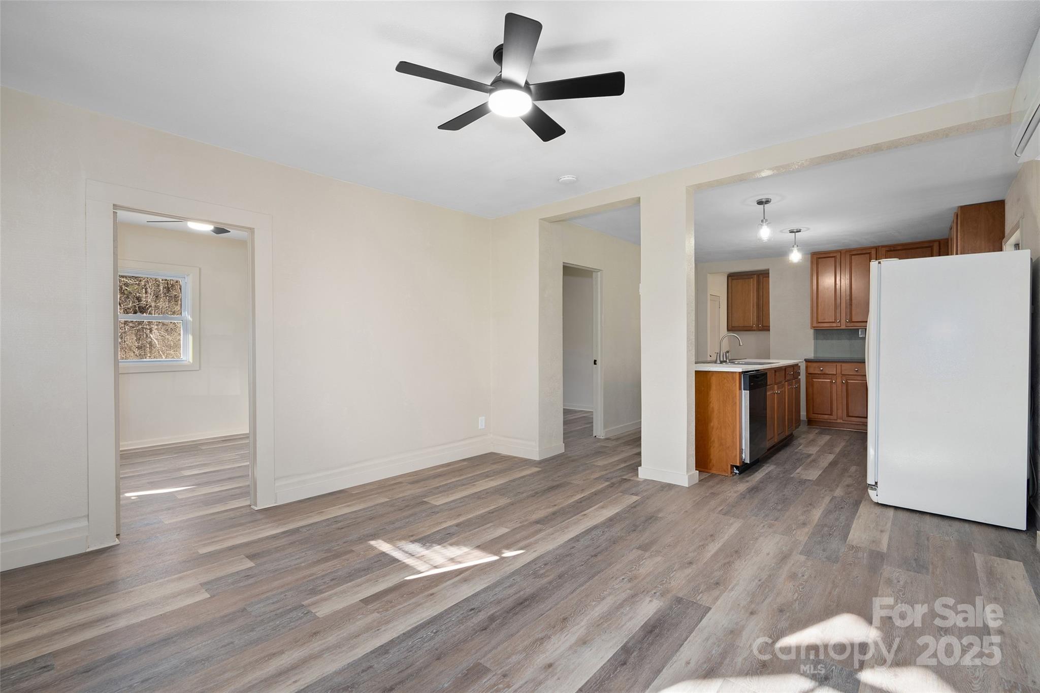1901 Murray Road Canton, NC 28716 - Photo 6 of 21 a view of empty room with wooden floor and ceiling fan