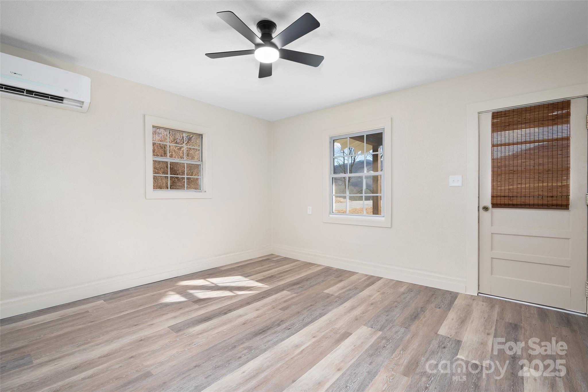 1901 Murray Road Canton, NC 28716 - Photo 8 of 21 a view of empty room with wooden floor and fan