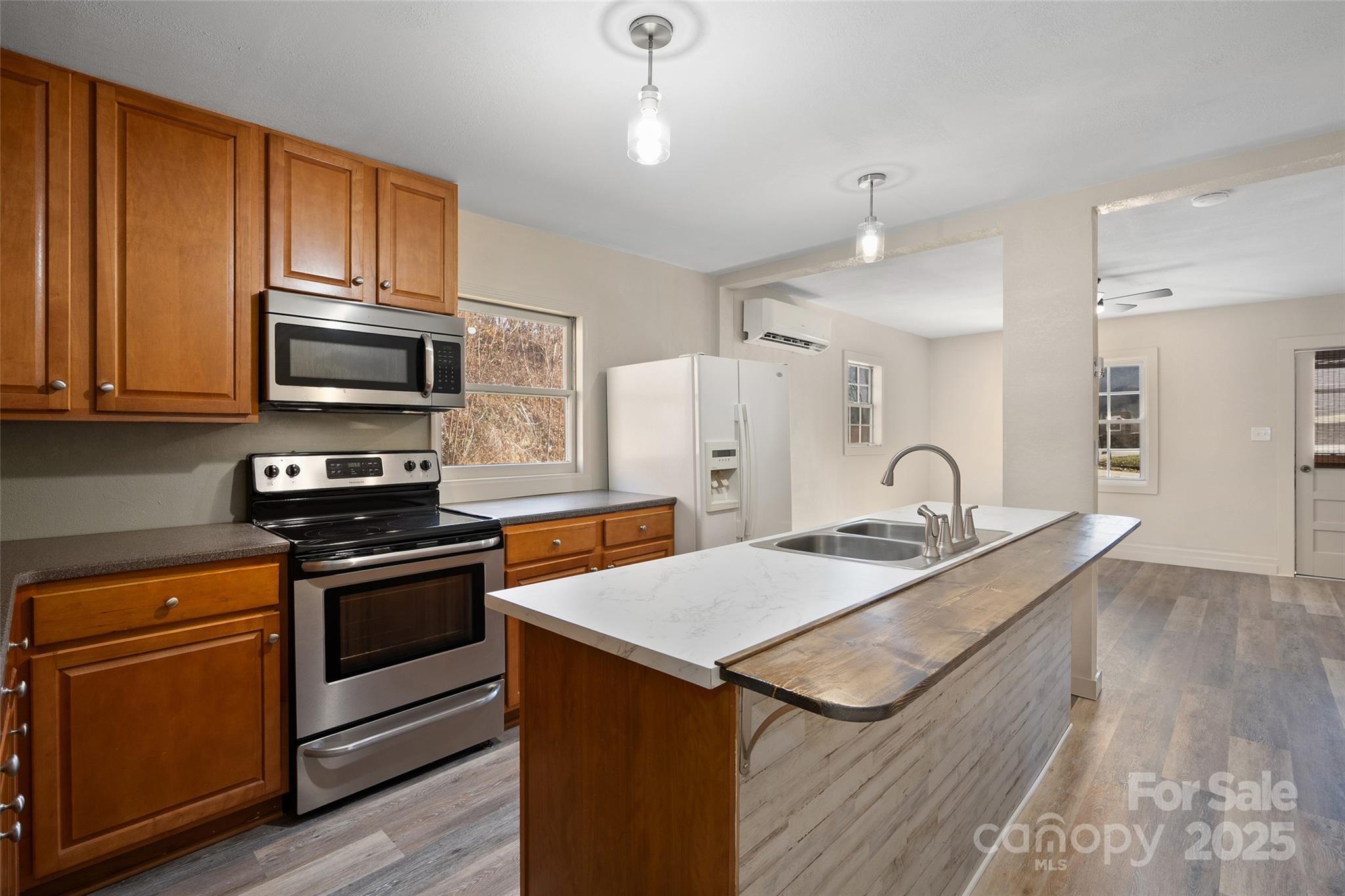 1901 Murray Road Canton, NC 28716 - Photo 9 of 21 a kitchen with stainless steel appliances granite countertop a stove a sink and a microwave