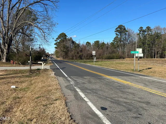 a view of a yard with trees in the background