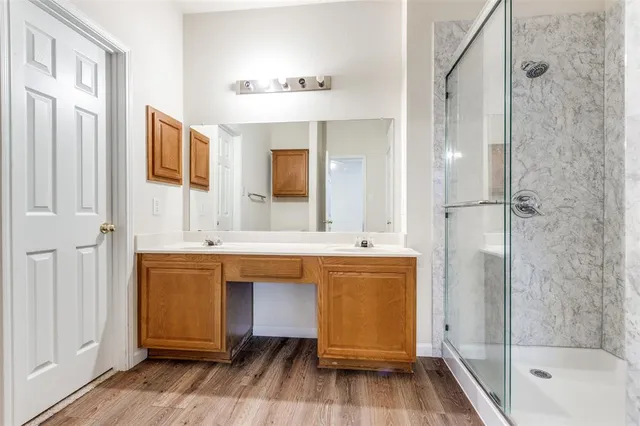 a bathroom with a tub a sink and a mirror