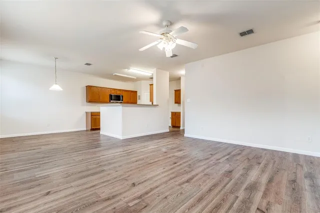 a view of a kitchen with a dishwasher and wooden floor