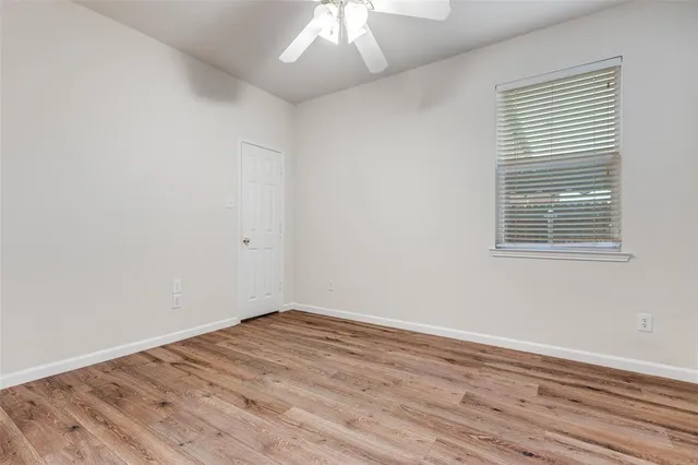 wooden floor in an empty room with a window