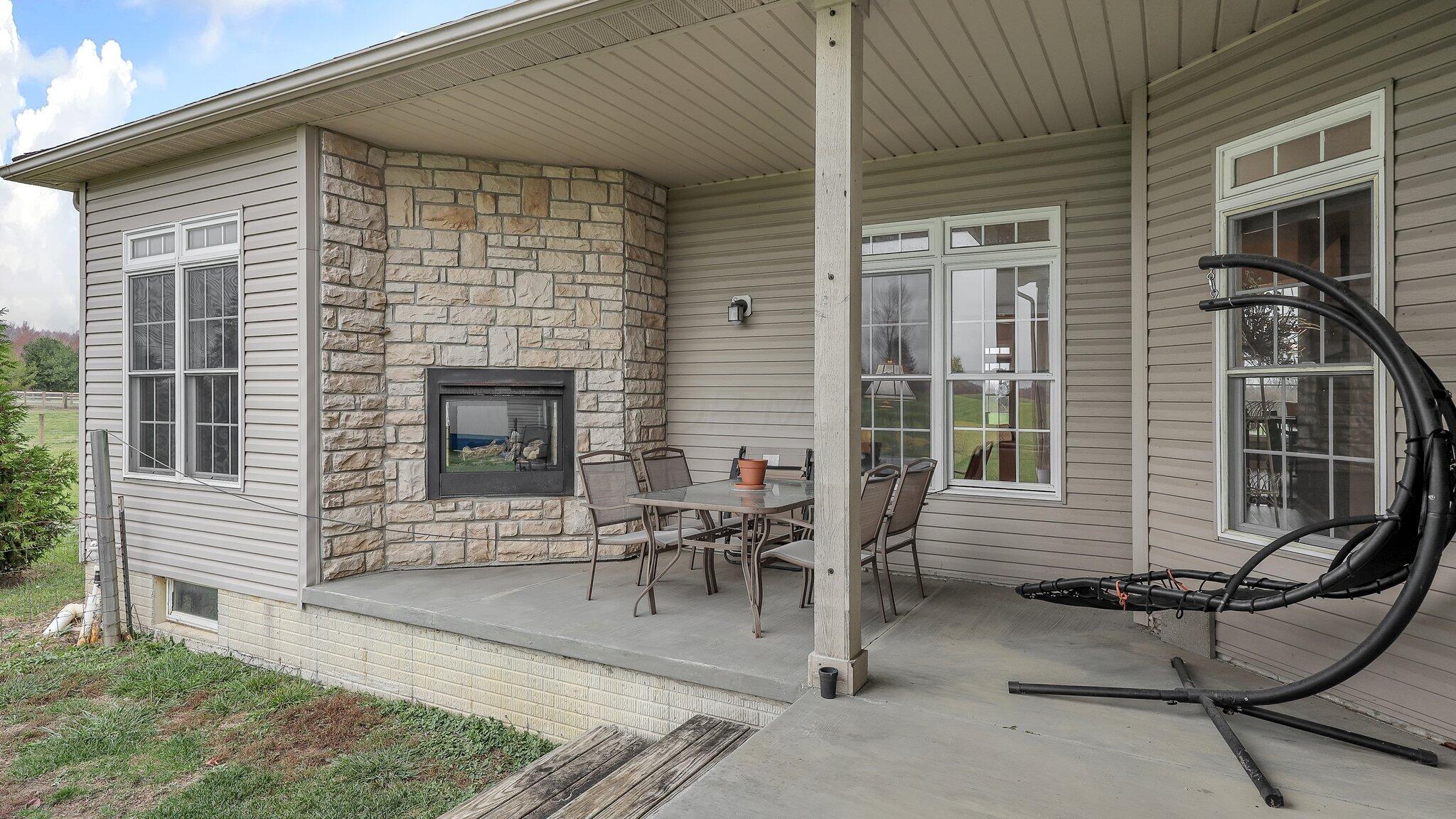 21729 Liberty West Road Raymond, OH 43067 - Photo 19 of 50 Step out to covered porch featuring fireplace