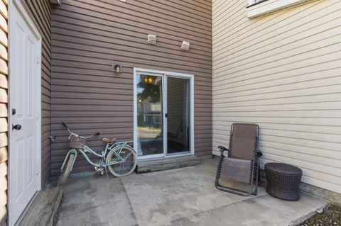 a view of a chair and fire pit in the backyard