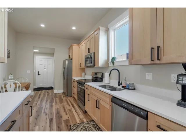 a kitchen with a sink cabinets and stainless steel appliances