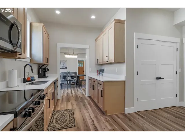 a open kitchen with sink cabinets and wooden floor