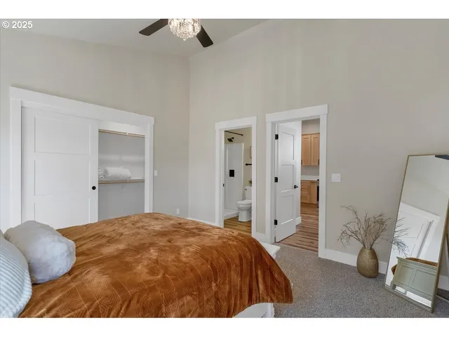 a bedroom with a bed and a mirror