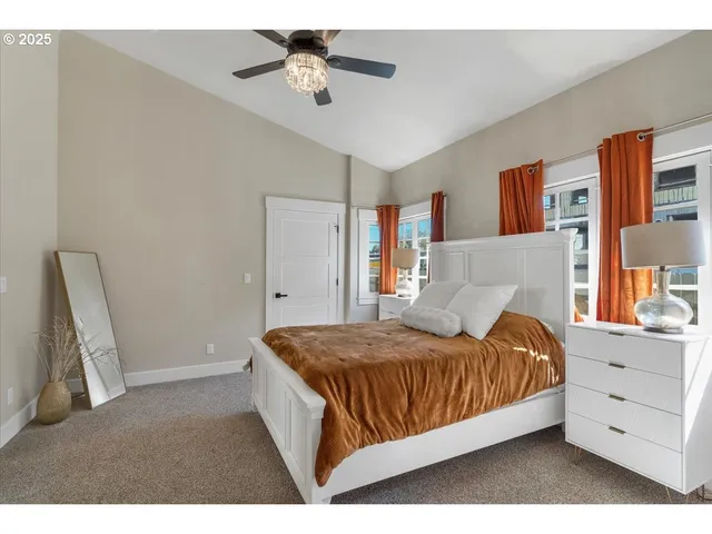 a bedroom with a large bed and a chandelier