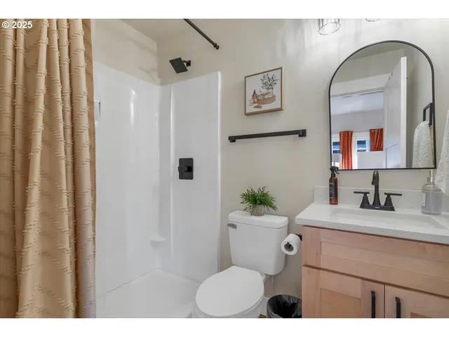 a bathroom with a toilet a sink and mirror