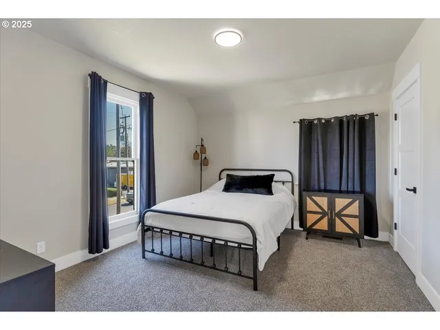 a bedroom with a bed and window