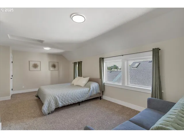 a bedroom with a large bed and a couch