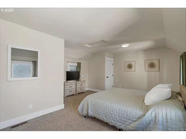 a bedroom with a bed and a television