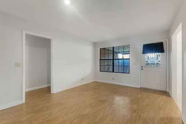 an empty room with windows and closet