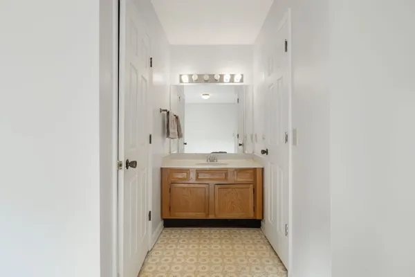 a bathroom with a sink a mirror and a bathtub