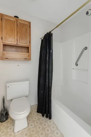 a bathroom with a toilet and a bathtub