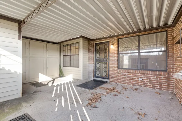 a view of a patio with table and chairs and wooden floor