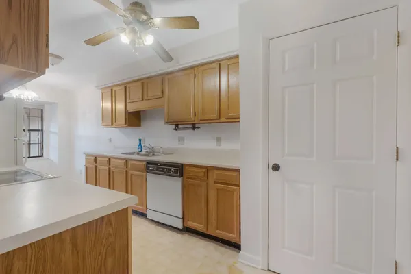 a kitchen with stainless steel appliances granite countertop a sink a stove a refrigerator a microwave oven with white cabinets