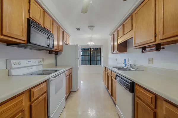 a kitchen with stainless steel appliances granite countertop a sink and a stove