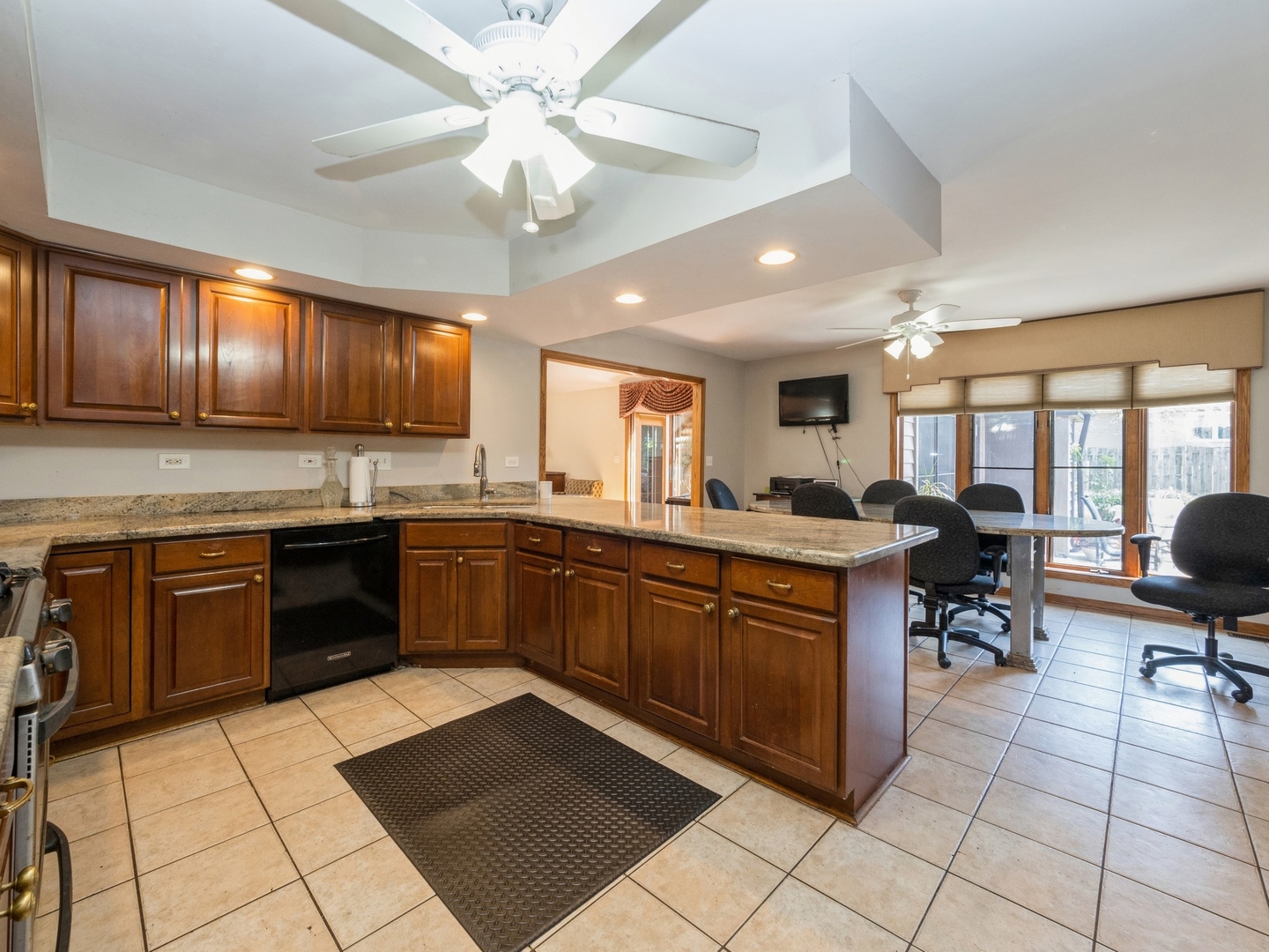 1149 North Doe Road Palatine, IL 60067 - Photo 12 of 46 a kitchen with stainless steel appliances granite countertop a stove granite counter tops and a view of living room