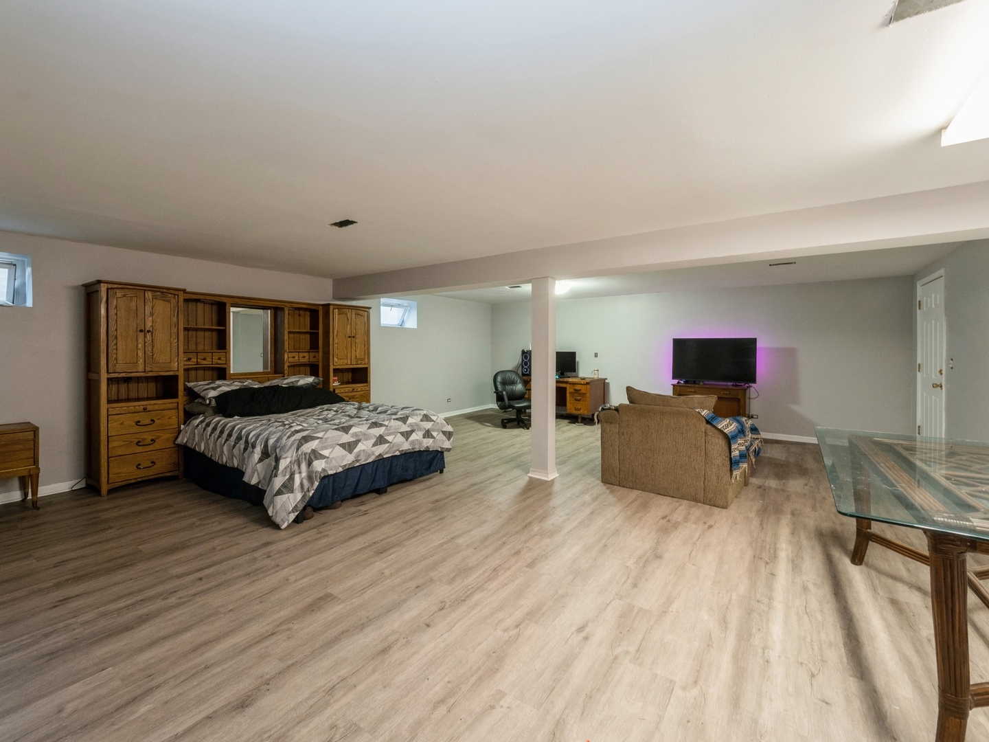 1149 North Doe Road Palatine, IL 60067 - Photo 34 of 46 a spacious bedroom with a bed a table and a dresser