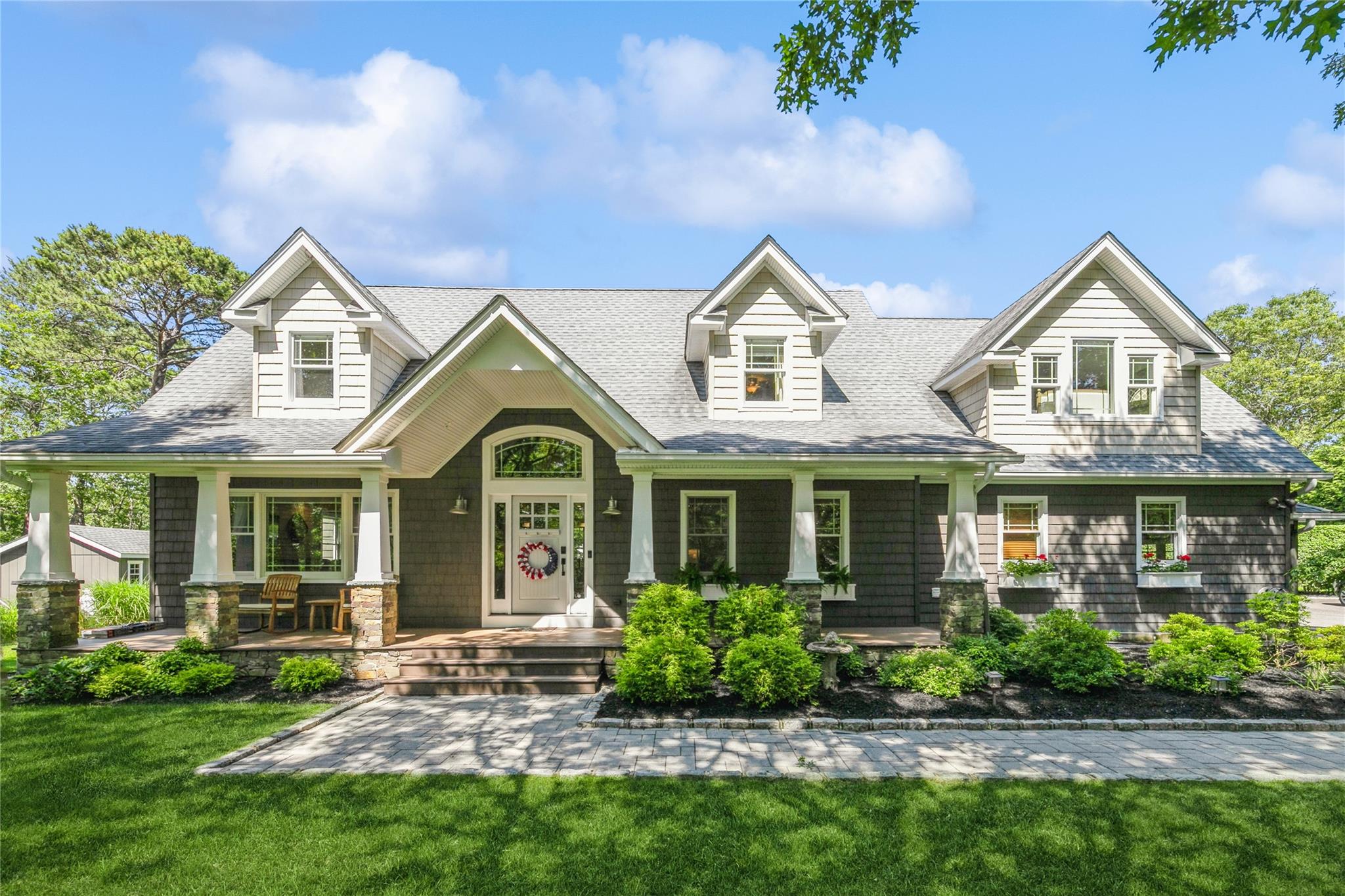 5 Hildreth Road South Hampton Bays, NY 11946 - Photo 1 of 1 View of front of property featuring covered porch, a shingled roof, and a front yard