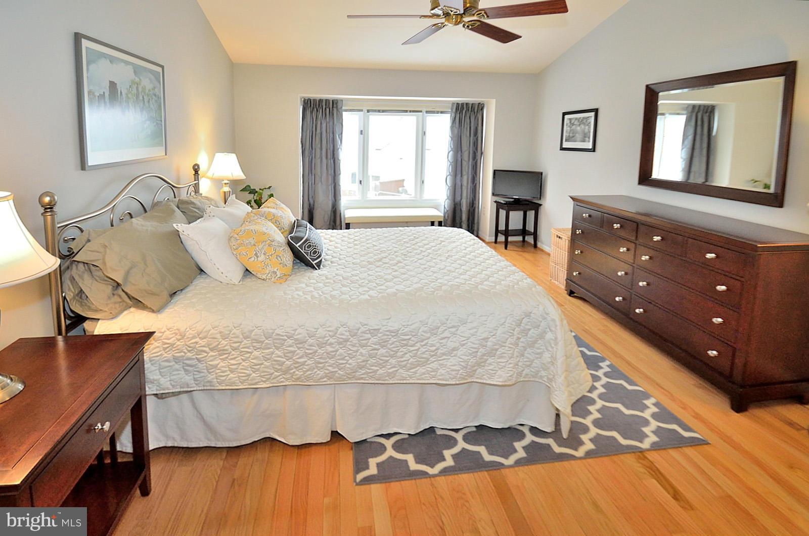 1283 Wedgewood Manor Way Reston, VA 20194 - Photo 14 of 27 a bedroom with a bed and wooden floor